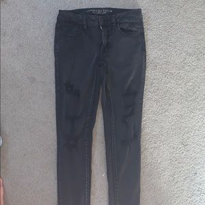 Distressed black jeans.